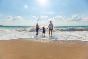 Family enjoying a relaxing time on the beach knowing their home is protected