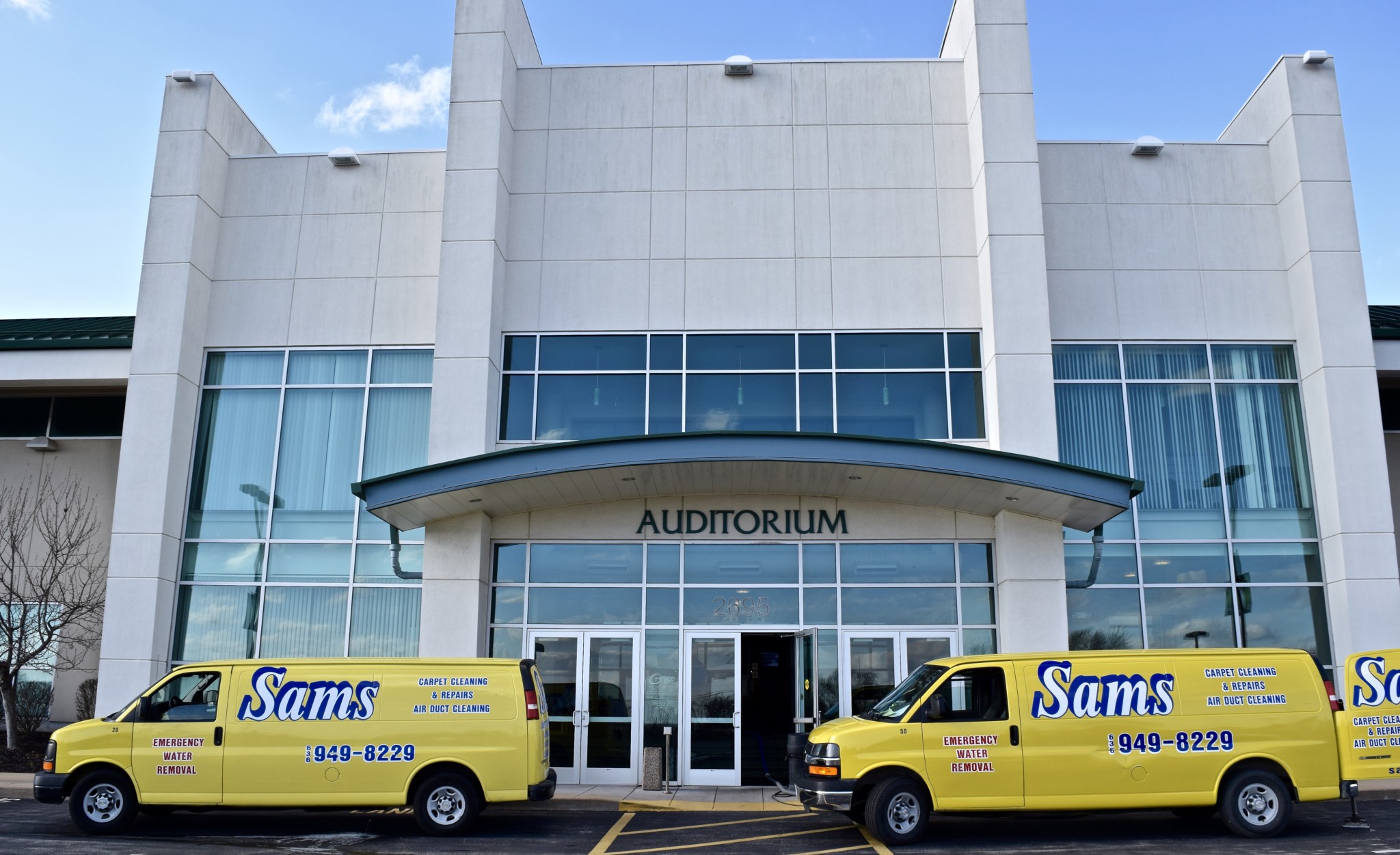 Sams Carpet Cleaning and Repairs van parked outside a commercial building in the St. Louis area