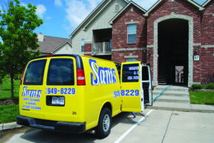 Sams Carpet Cleaning and Repairs van parked outside an apartment building ready to clean the carpets.