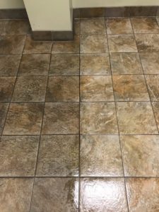 An image depicting dirty tile and clean tile, side by side