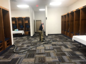 Sams Carpet cleaning technician cleaning carpets in America's Center locker room